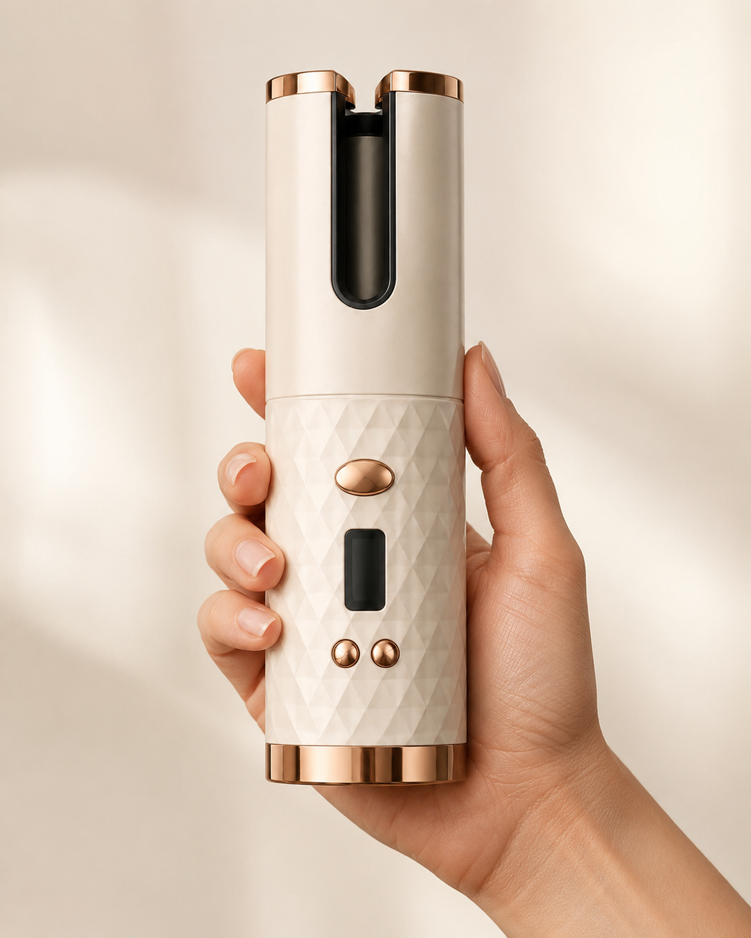 Scolora Coil cordless curler held in hand to show its compact size